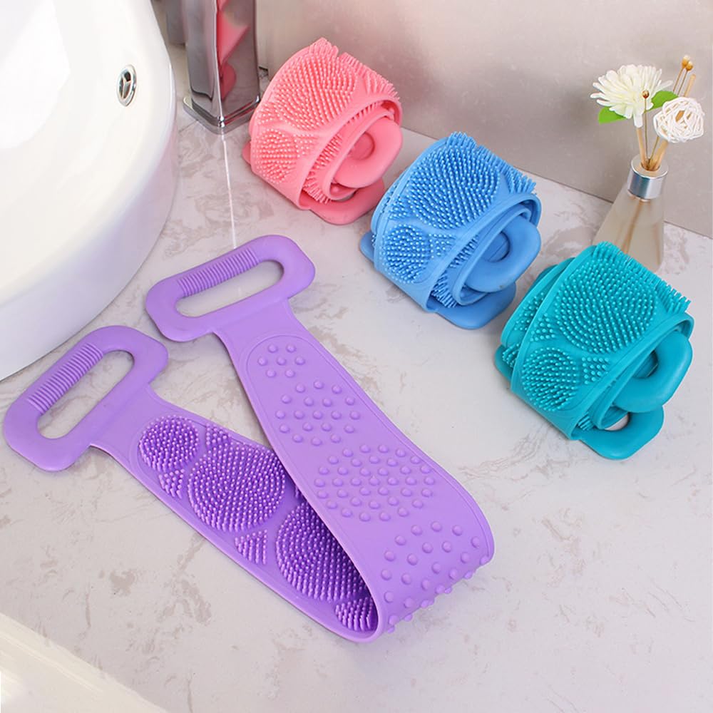 Set of four silicone scrubbers in purple, pink, blue, and green on a bathroom counter.